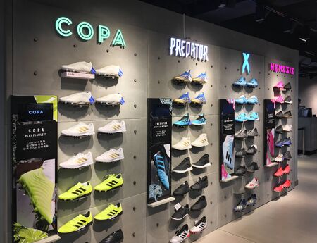 HONG KONG - SEPTEMBER 20, 2019: Various shoes at an Adidas store in Tsim Sha Tsui. Adidas AG is a German corporation, the largest sportswear manufacturer in Europe and the second biggest in the world.のeditorial素材