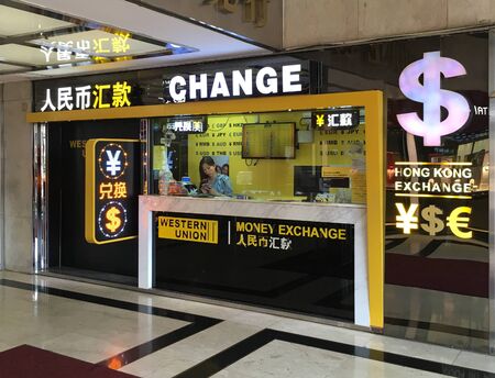 HONG KONG - SEPTEMBER 20, 2019: A woman works at a money exchange booth at the Star House mall.のeditorial素材