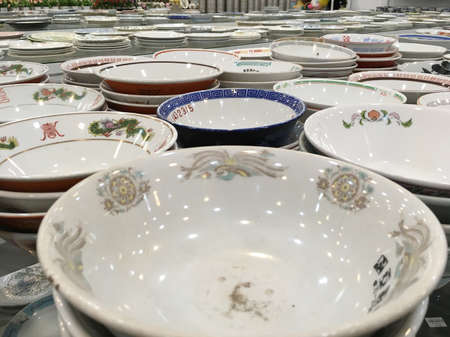 SIEM REAP, CAMBODIA - APRIL 27, 2020: Lots of tableware and crockery for sale at Sakura recycle shop of second hand goods.のeditorial素材