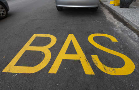 big letters BAS painted on road surfaceの写真素材