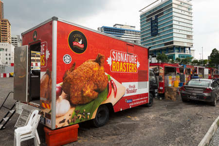 KUALA LUMPUR - MARCH 13, 2017: A line of street food trucks in the beginning of Jalan Alor Street famous with budget restaurants of various cuisines of the world.のeditorial素材