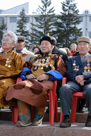 ULAN-UDE, RUSSIA - MAY 9: Elderly buryat veterans of WWII sit at tribunes and watch the parade on annual Victory Day.のeditorial素材