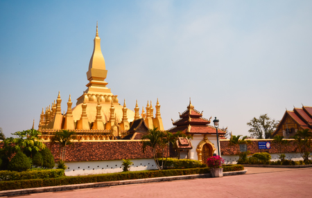 Golden buddhist pagoda of Phra That Luang Temple under blue sky. Vientiane, Laoのeditorial素材