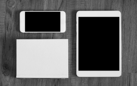 White smart phone and tablet pc on the working deskの写真素材