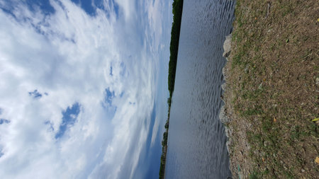 blue sky with white clouds over the river. panoramic viewの写真素材