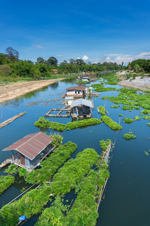 Raft homes with green eco floating farms in a river of Thailandの写真素材