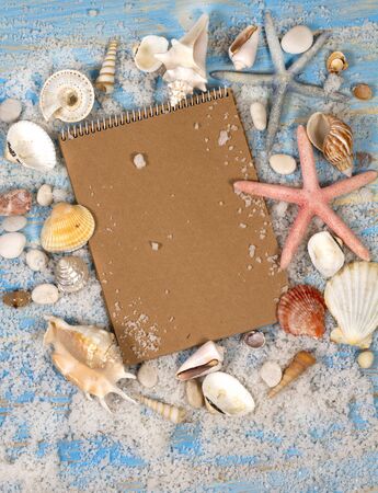 Open notebook with seashells and starfish. Planning summer holidays, travel and vacation background.の写真素材