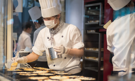 A chef is preparing pastry for bakery storeのeditorial素材