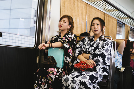 Osaka, Japan - JULY : women in kimono dress sitting in train July 20, 2013のeditorial素材