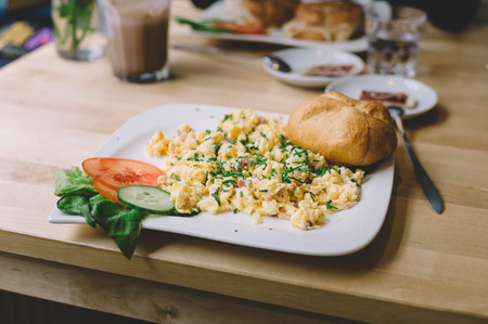 scrambled eggs with bacon and bread and cheeseの写真素材