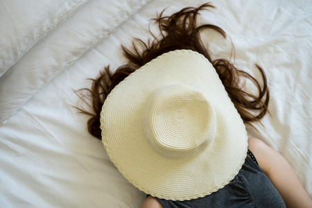 hat cover woman face she is nappingの写真素材