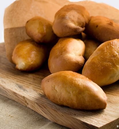 Pies on a wooden board. A batch.の写真素材