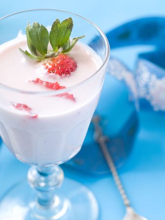 Strawberry cocktail  with garnish. On blue backgroundの写真素材