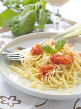 Spaghetti with a tomato sauce, cheese and a basilの写真素材