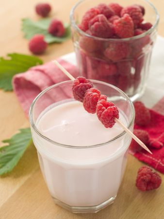 Yogurt with fresh raspberries for breakfastの写真素材