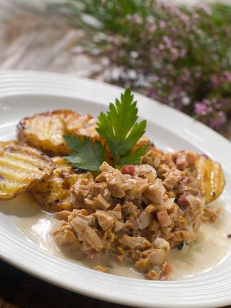 Fried potatoes with chanterelle serving on plateの写真素材