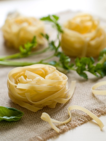 Pasta ingredients; fresh tagliatelle, garlic,basil  Selective focusの写真素材