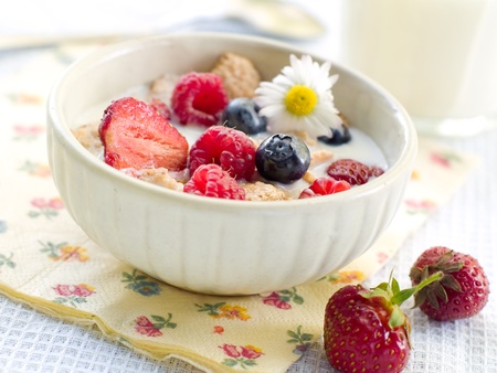 Oat flakes with berries and milk for breakfast. Selective focusの写真素材
