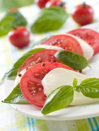 Tomato and cheese appetizer with olive oil and basil. Selective focusの写真素材