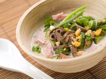 Fresh asian soup in bamboo bowl. Selective focusの写真素材