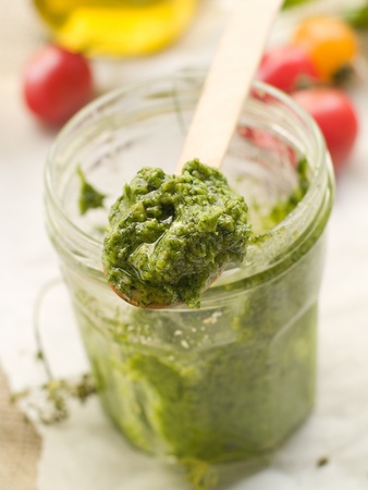 Fresh green pesto in wooden spoon. Selective focusの写真素材