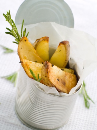 Roasted potatoes with herbs in metal tin. Selective focusの写真素材