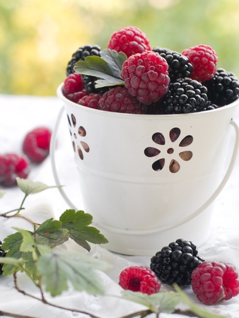Assorted berries in bucket on natural background. Selectve focusの写真素材