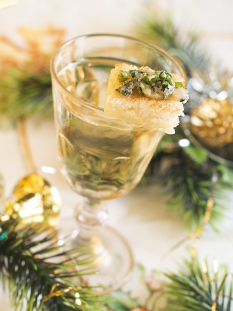 A glass of white wine with snack, selective focusの写真素材