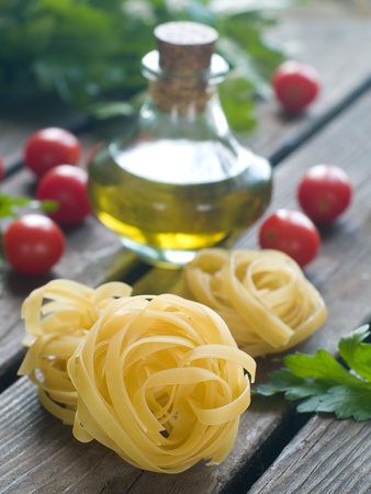 Pasta ingredients; fresh tagliatelle, tomato, parsley,selective focus の写真素材