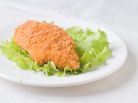 Breaded chicken fillet with lettuce, selective focusの写真素材