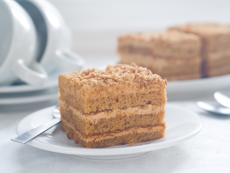 Honey cake with tea cups, selective focusの写真素材