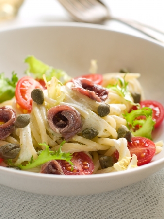 Pasta with frsh tomatoes, anchovy and capers, selective focusの写真素材