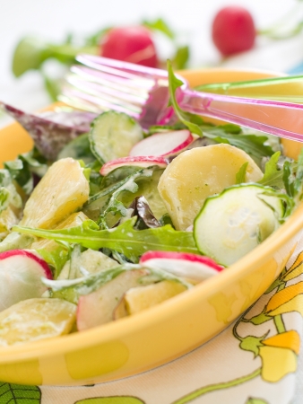 Fresh salad with cucumber, radishes and potatoes, selective focusの写真素材