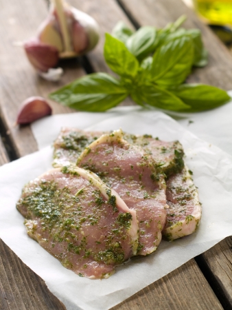 Fresh pork meat in green marinade, selective focusの写真素材
