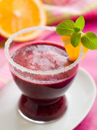 Berry smoothie  or juice with orange and mint, selective focus の写真素材