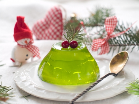 Peppermint jelly on a plate with christmas decoration, selective focus 