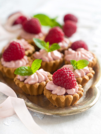 Raspberry tartlets with cream and fresh berry, selective focusの写真素材
