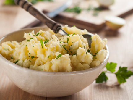 A bowl of mashed potatoes with spoon, selective focusの写真素材
