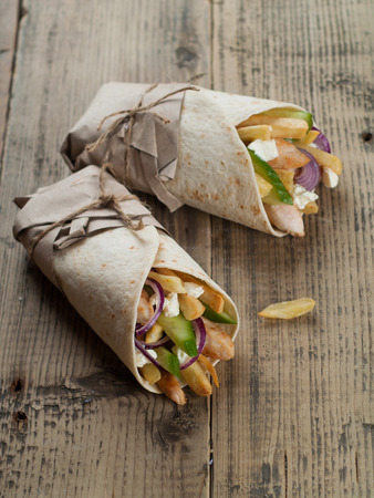 Fresh tortilla wraps with grilled chicken,vegetables and potato, selective focusの写真素材