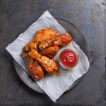 Grilled chicken leg with tomato sauce, selective focusの写真素材