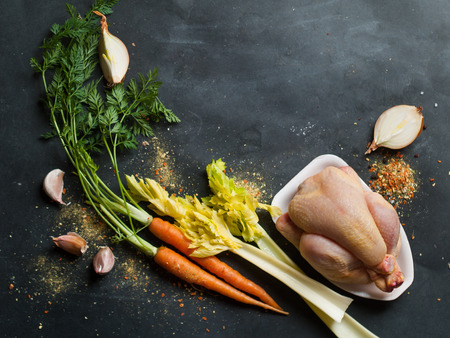 Fresh chicken and vegetables on dark vintage background, selective focus. Healthy food, diet or cooking conceptの写真素材