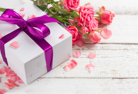 Roses and gift on wooden board, Valentines Day background, selective focusの写真素材