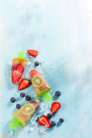 Frozen and iced fuit - strawberry,kiwi, blueberry and coconut water, selective focusの写真素材