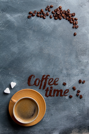 Coffee composition with cup and coffee bean on dark background, selective focusの写真素材
