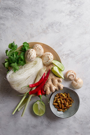 Ingredients for spicy asian food with fried insect (silk worm), top view, selective focusの写真素材