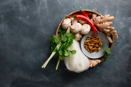 Ingredients for spicy asian food with fried insect (silk worm), top view, selective focusの写真素材