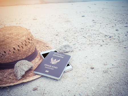 Preparation for travel,trip vacation, tourism mock up of cell phone,hat on sand.,Summer vacation, beach accessories on sandの写真素材