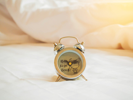 Vintage alarm clock on the bed