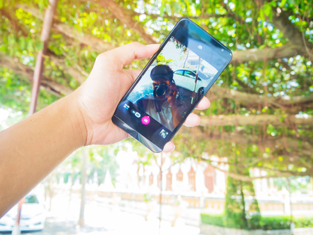 Hand held mobile phone screen taking a photo