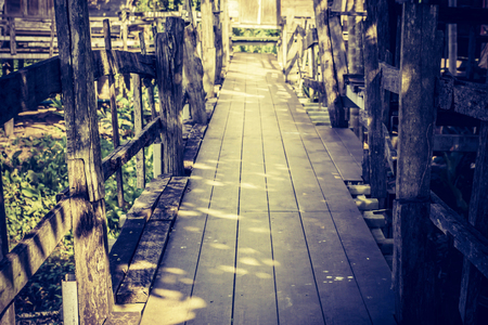 Old elevated wooden boardwalk in a rural environment, walkway.の写真素材